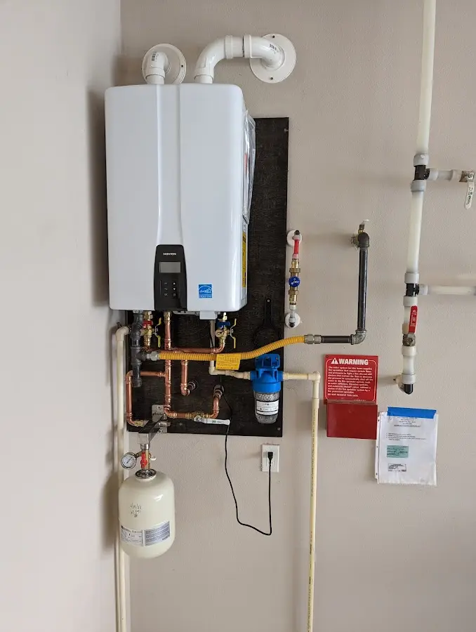 Professional plumber installing copper piping in a Westmoreland home